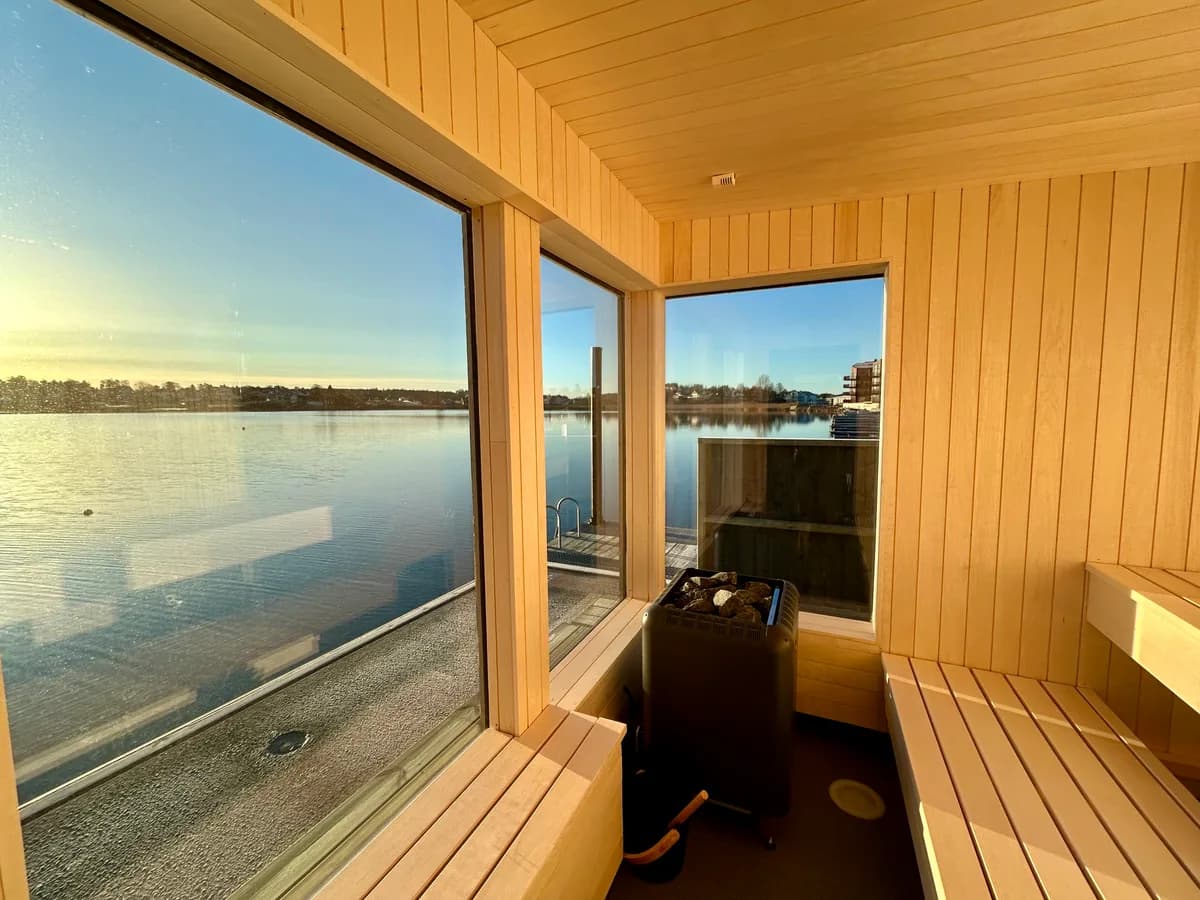 Sjøbadet Badstue Hjemseng Brygge – interiør Interiør i Sjøbadet Badstue Hjemseng Brygge med panoramavinduer og sjøutsikt i Husøysund