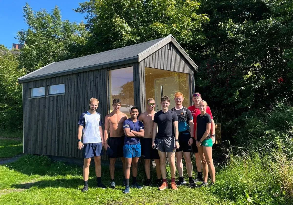 Fram Badstu i Larvik, mørkt trehus med stort vindu ved Rekkeviksbukta