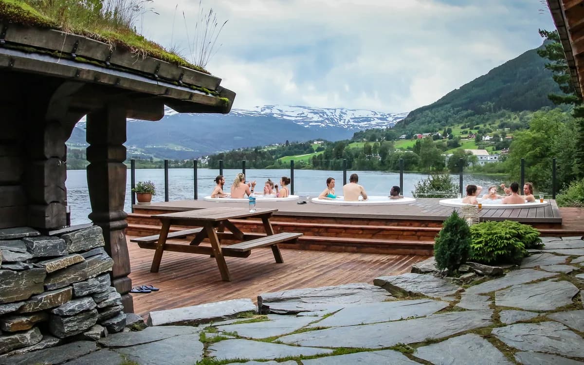 Utendørs boblebad ved Elvatun Friluftsspa i Skulestadmo med fjell- og elveutsikt
