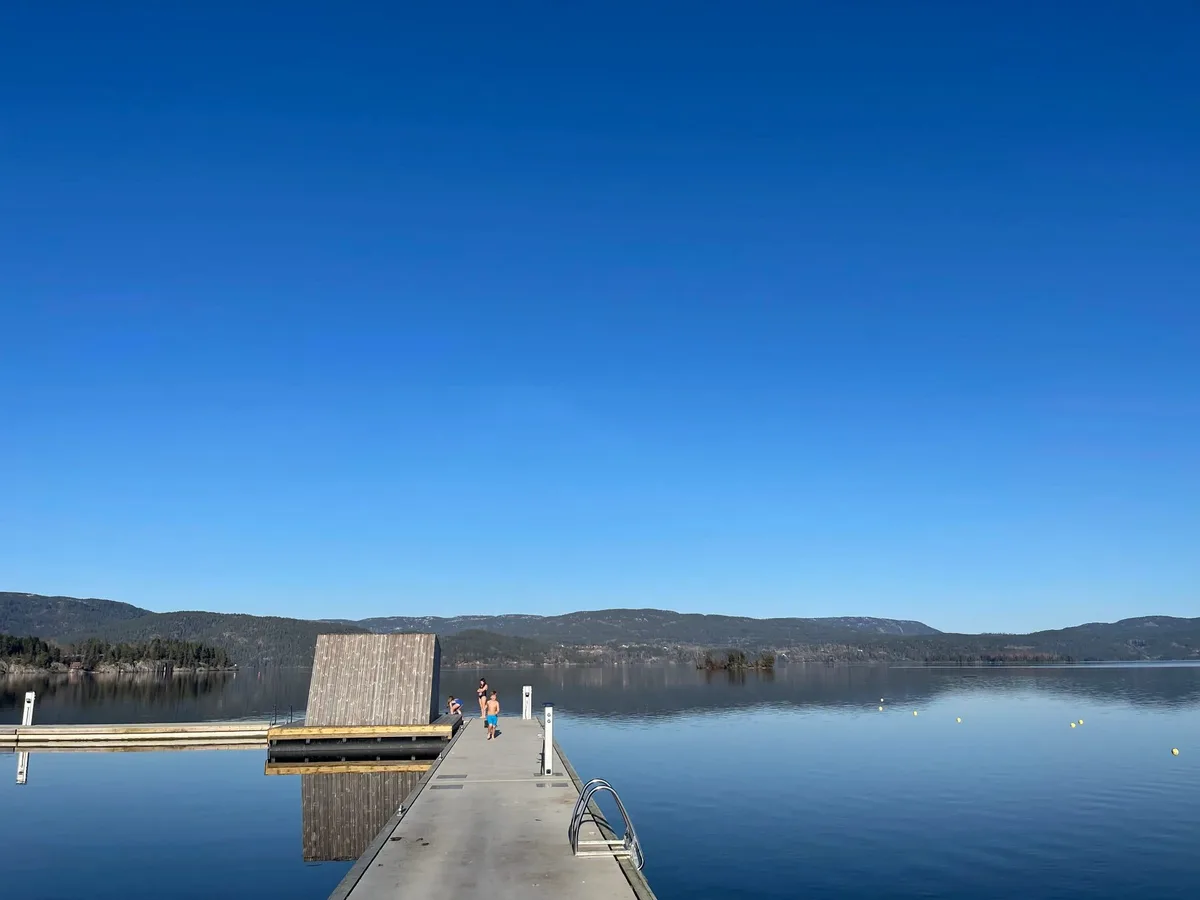 Flytende badstue ved brygga på Ulefoss en sommerdag med utsikt over Norsjø